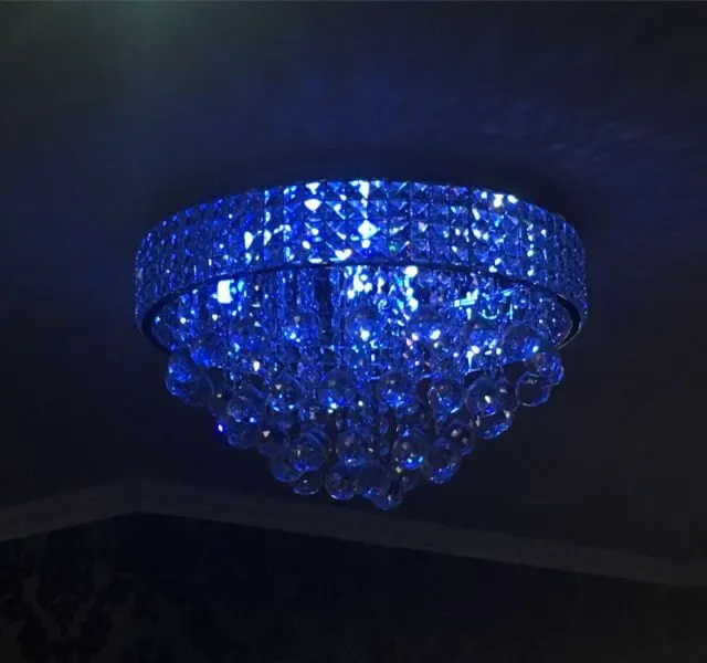 A blue glass chandelier lighting the dining room