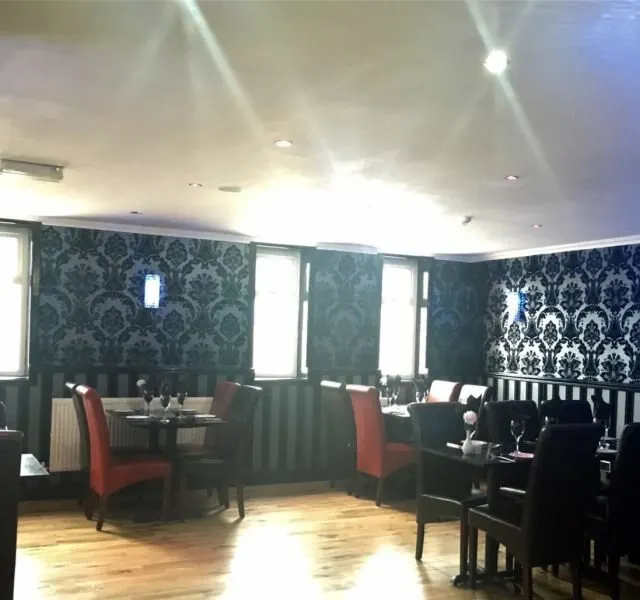 Tables set for dinner along the window of the dining room