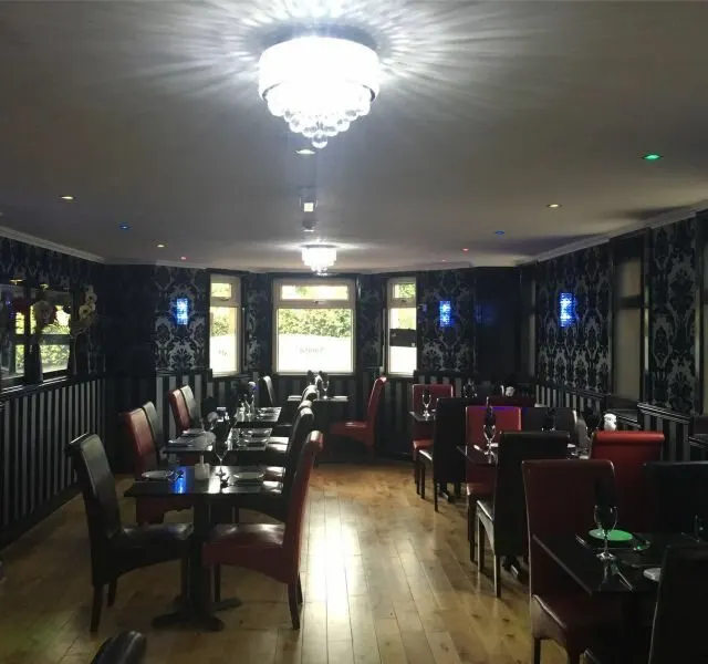 Set tables and high-backed chairs in the dining room
