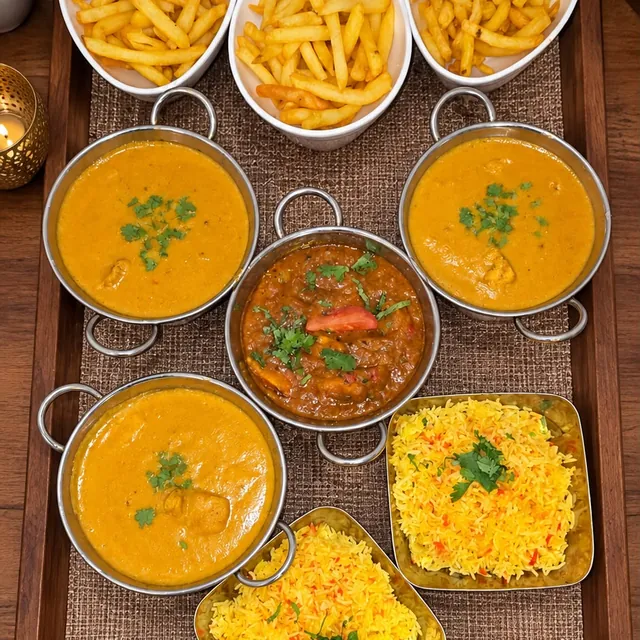 A family feast of curries, pilau rice and chips