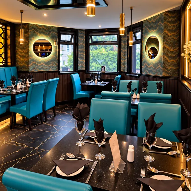 The dining room at Mumbai Lounge, with backlit round mirrors and gold pendant lights