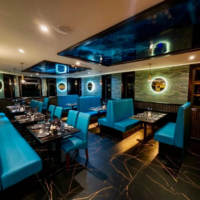The refurbished dining room at Mumbai Lounge, with teal booth seating and a starlit ceiling panel