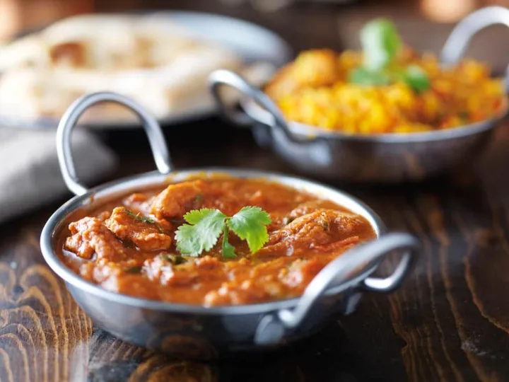 A rich karahi curry with pilau rice and naan bread
